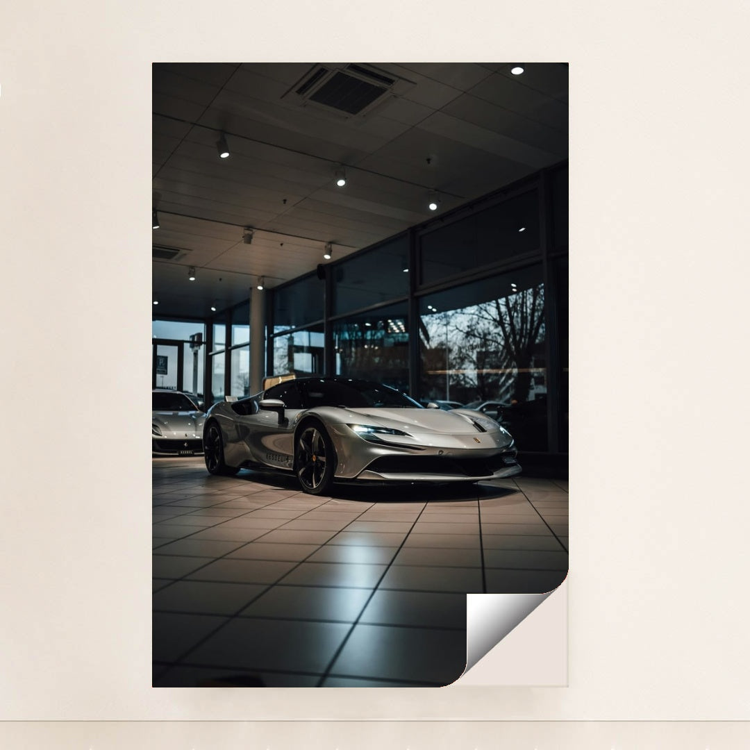 This photo shows a silver Ferrari SF90 Stradale parked inside a showroom with large windows, unframed style.