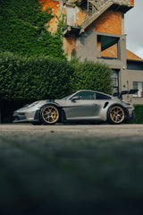 Silver Porsche 911 GT3 RS in City Hideaway with bronze wheels in lush greenery and aged architecture. Car wall art.