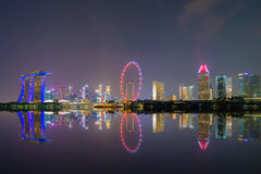 Stock Photos - Singapore Downtown skyline at night with reflection. Financial district and business centers in technology smart urban city in Asia. Skyscraper and high-rise buildings.