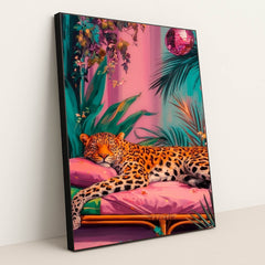 This artwork shows a lounging leopard on a pink couch surrounded by tropical plants and a sparkling disco ball, in a black frame.