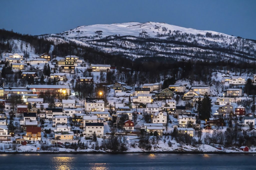 Pixabay - Charming snowy village set against Norwegian winter landscape illuminated at twilight.