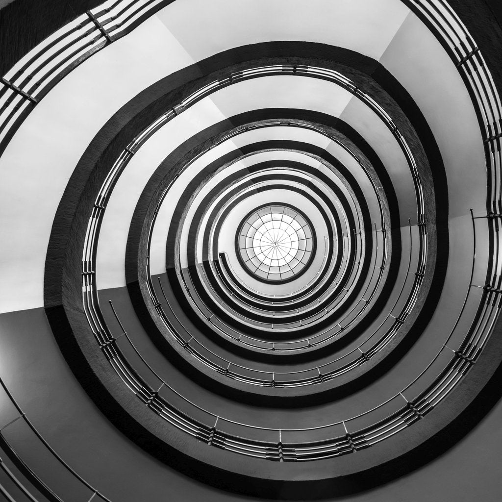 Wolfgang Weiser - Monochrome view of a geometric spiral staircase design in Hamburg.