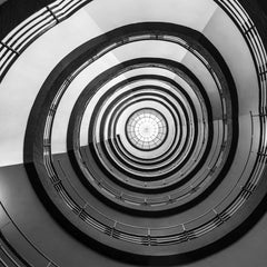 Wolfgang Weiser - Monochrome view of a geometric spiral staircase design in Hamburg.