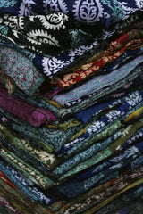 Batuhan Küçükdemir - Vibrant stack of traditional Turkish textiles showcasing diverse patterns and colors in Gaziantep.