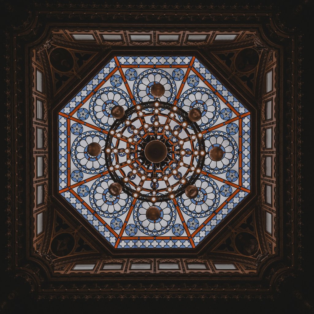 Willian Santos - A majestic stained glass dome ceiling viewed from below, showcasing detailed geometric patterns.