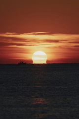 Tolga Ahmetler - A breathtaking sunset view over the sea with warm tones and a silhouette of a boat in Istanbul, Turkey.