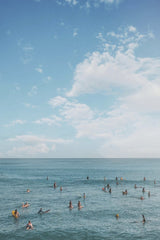 Jess Loiterton - Surfers and swimmers enjoy a sunny day on a pristine beach in Honolulu, capturing the vibrant island life.