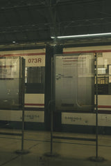 Noland Live - A vintage train station with reflective panels and classic train design.