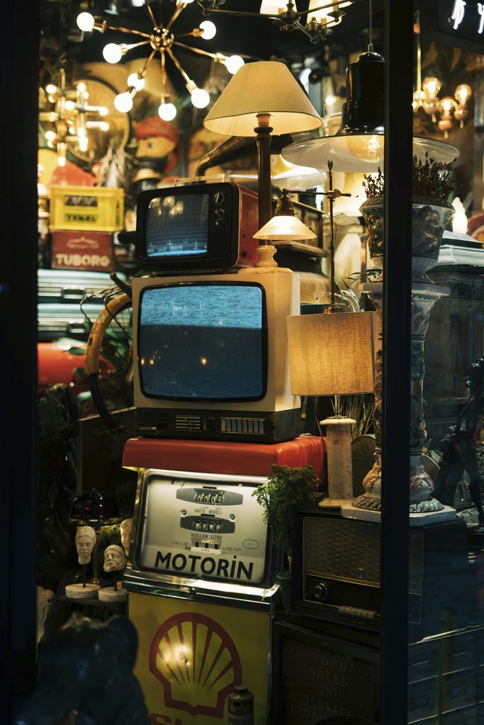 Sami Abdullah - Eclectic vintage shop display in Istanbul with retro TVs and lamps.