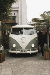 Usman AbdulrasheedGambo - A classic Volkswagen van surrounded by palm trees in a Shanghai urban setting.