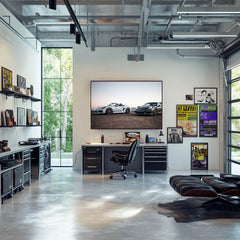 Porsche Duo at Dusk car wall art in modern office setting featuring a white Boxster Spyder and graphite Cayman GT4.