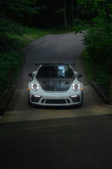 Porsche 911 GT3 RS by the Forest Road, a sleek white car on a tranquil wooded road, perfect for car wall art.