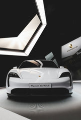 Porsche Taycan Turbo S in the Spotlight showcased as car wall art in a modern showroom with sleek lighting.