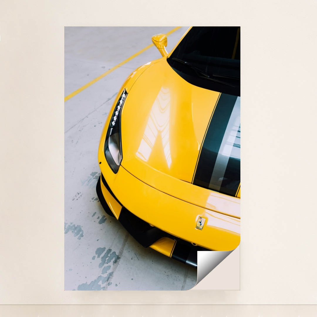 This photo shows the front end of a yellow Ferrari 488 Pista with black and silver racing stripes indoors, unframed style.
