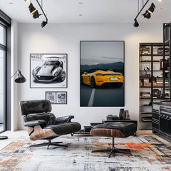 Modern living room featuring car wall art, showcasing a Racing Yellow 718 Spyder at dusk on the wall.