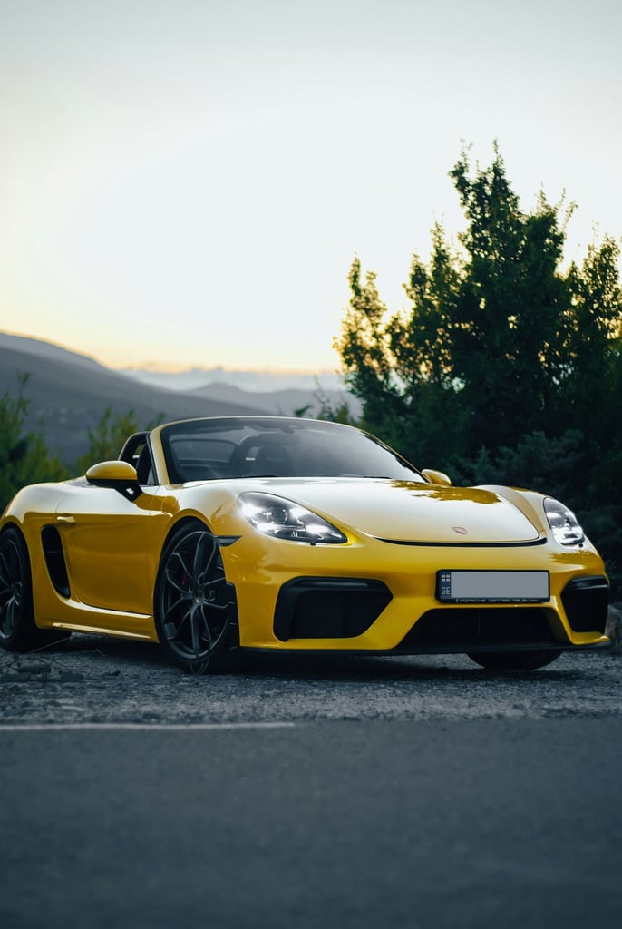 Porsche 718 Spyder Against the Horizon, striking yellow car wall art, featuring luxury styling at sunset.