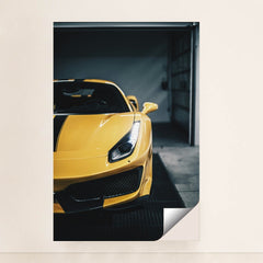 This photo shows the front left side of a yellow Ferrari with sharp headlights and black striping, parked indoors, minimalist unframed style.