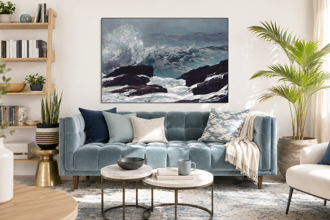 Large ocean wave wall art centered above a light blue sofa in a bright coastal-style living room
