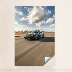 Porsche 911 on Open Highway, deep green sports car racing on empty road under a blue sky, perfect for car wall art.