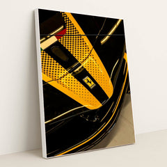 Close-up of Ferrari Nose Detail showcasing black finish, yellow racing stripe, and iconic badge. Perfect car wall art.