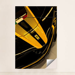 Close-up of Ferrari Nose Detail with black finish, yellow racing stripe, and iconic badge, perfect for car wall art.