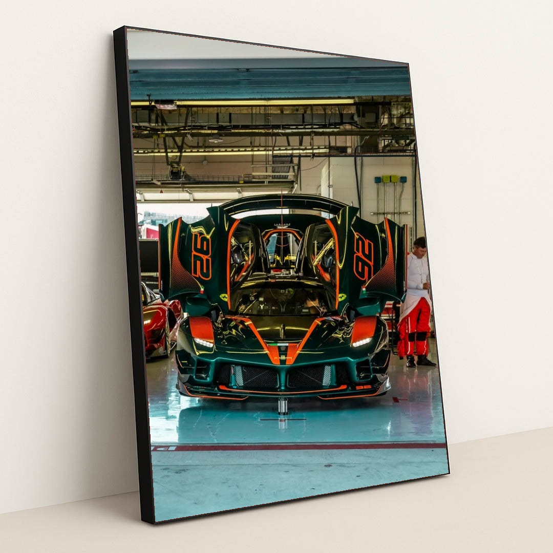 Ferrari FXX-K Evo in Pit Garage showcasing its stunning emerald green design and striking orange details as it displays dihedral doors.
