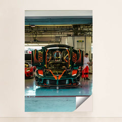 Ferrari FXX-K Evo in Pit Garage with dihedral doors raised, green and orange accents, showcasing its aerodynamic design.