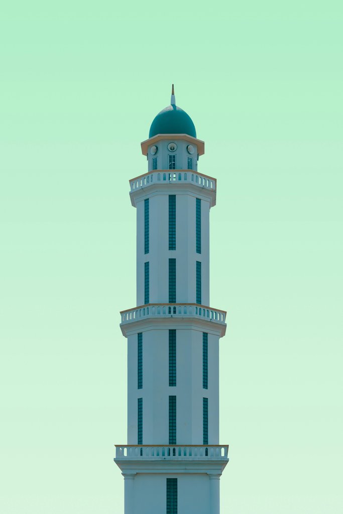 Mohammed Alim - A tall white tower with a green top