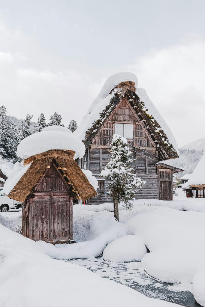 Hyungman Jeon - A snow covered village with a stream running through it photo