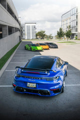 Luke Schobert - A blue sports car parked in a parking lot photo