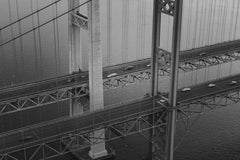 Josh Hild - Aerial shot of the Tacoma Narrows Bridge with vehicles crossing over water.