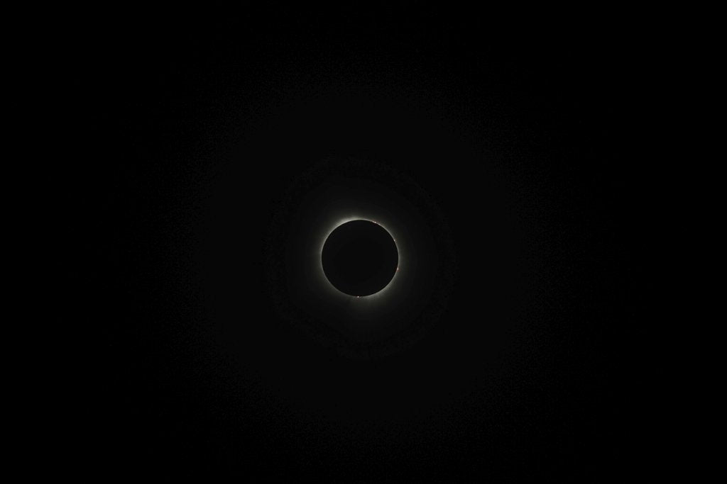 Kelly - A breathtaking view of a solar eclipse surrounded by darkness, showcasing the beauty of the night sky.