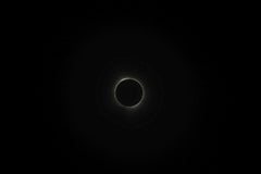 Kelly - A breathtaking view of a solar eclipse surrounded by darkness, showcasing the beauty of the night sky.