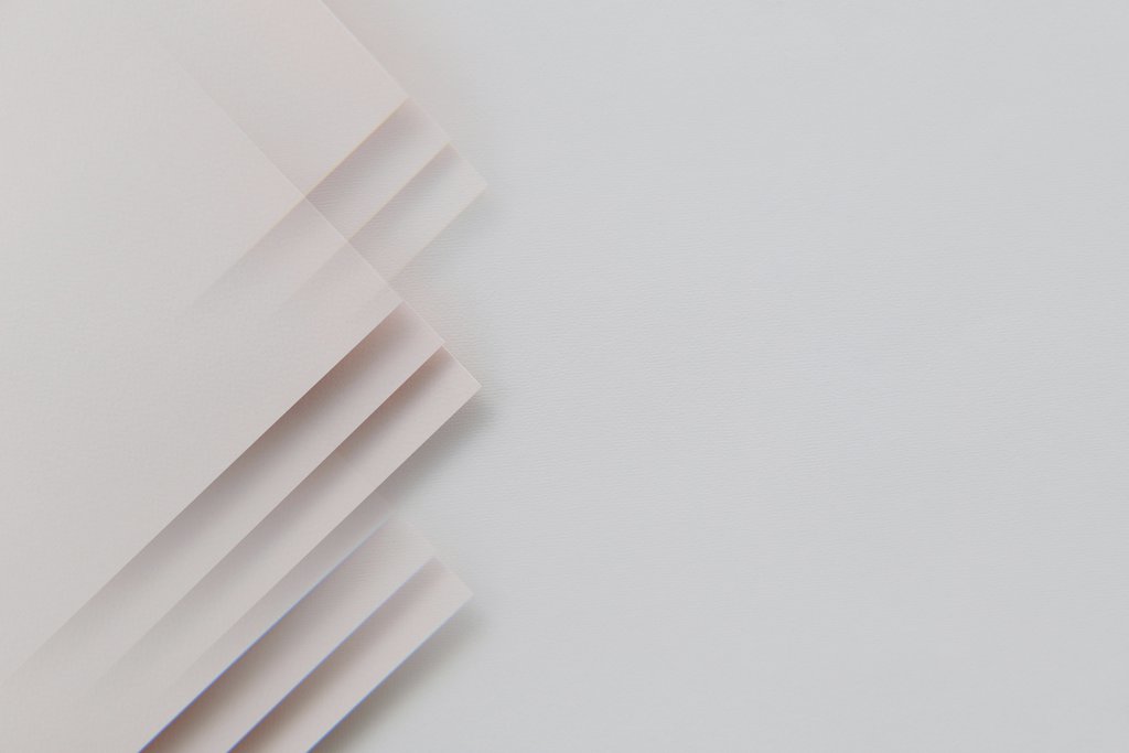 Edward Jenner - A minimalistic abstract composition featuring layered sheets on a gray surface, perfect for modern design.