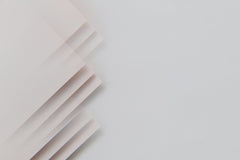 Edward Jenner - A minimalistic abstract composition featuring layered sheets on a gray surface, perfect for modern design.