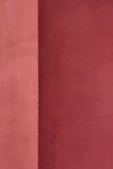 Yevhenii Deshko - Minimalistic image of a vibrant red wall showcasing geometric patterns and textures.