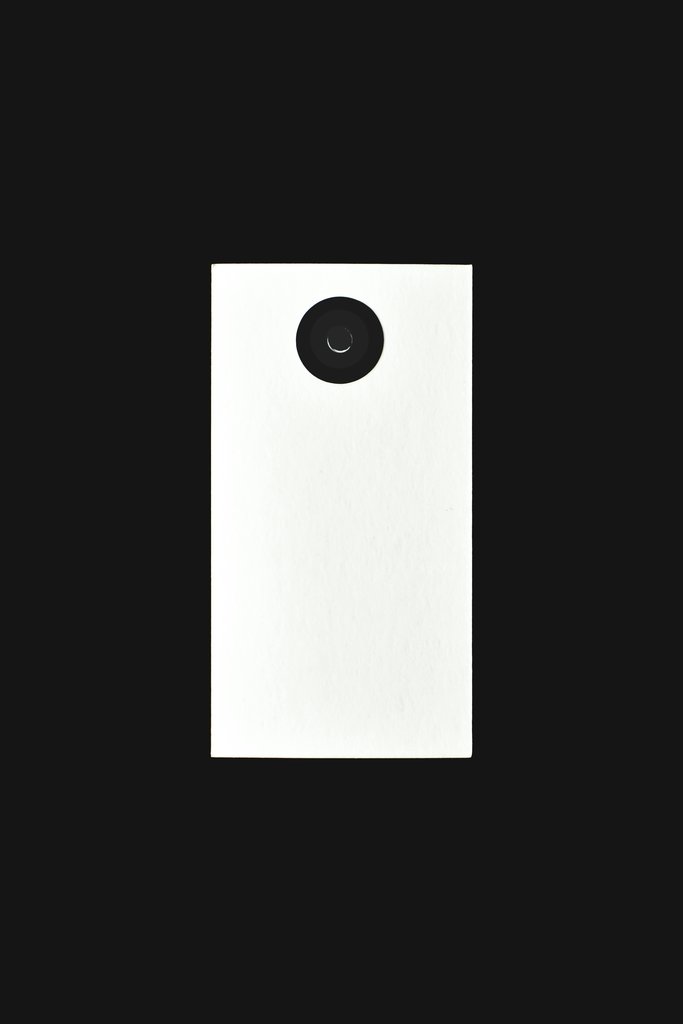 Eva Bronzini - Minimalist black and white design featuring a vertical view of a camera lens isolated on a dark background.