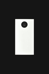 Eva Bronzini - Minimalist black and white design featuring a vertical view of a camera lens isolated on a dark background.