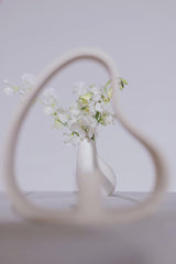 cottonbro studio - Artistic photo of a minimalist ceramic vase with white flowers framed by abstract shape.