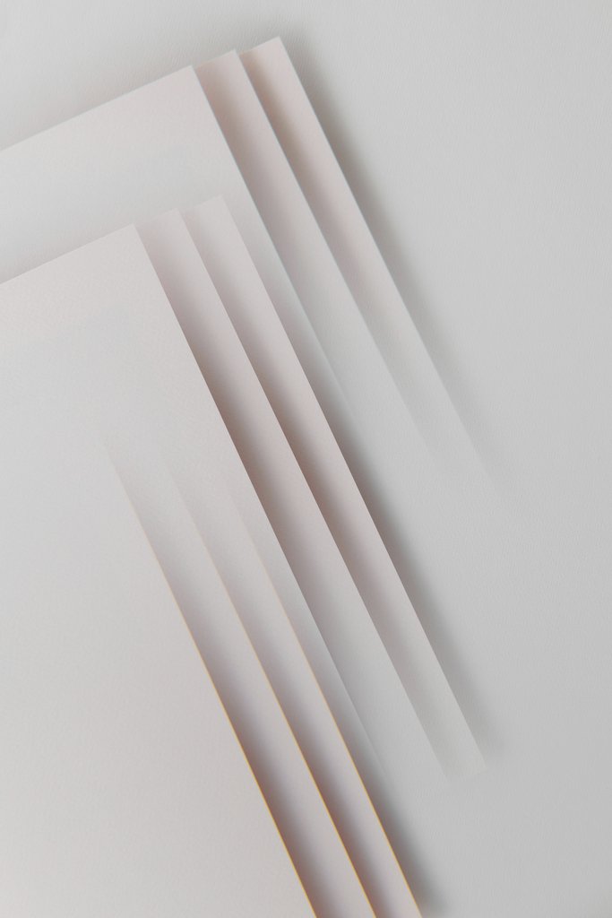 Edward Jenner - Minimalist abstract design featuring layered paper sheets creating geometric patterns.