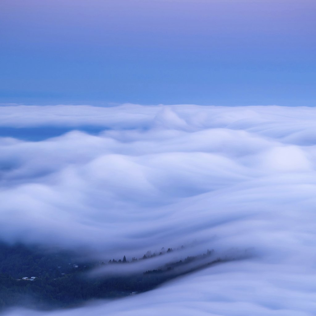 Zetong Li - An enchanting view of clouds resembling ocean waves during twilight.