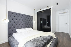Max Vakhtbovycn - A sleek bedroom design featuring a gray upholstered bed and elegant lighting, perfect for modern interiors.
