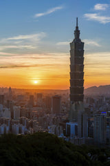 Timo Volz - Stunning view of Taipei 101 and skyline at sunset, highlighting urban architecture.
