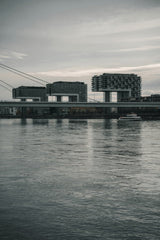 Cüneyt Demirli - View of the iconic Kranhaus buildings in Cologne, Germany reflecting on the Rhine River.