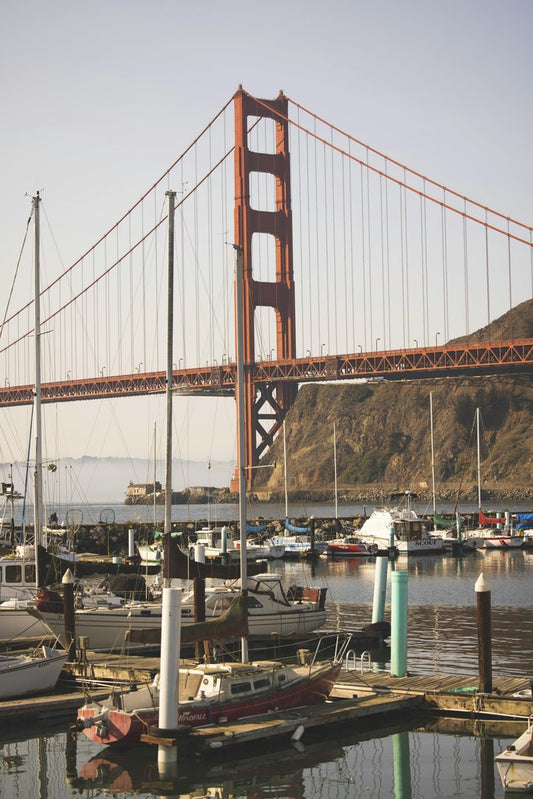 Stephen Leonardi - Golden Gate Bridge with boats docked at a marina on a clear day.