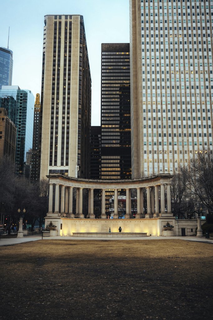 Mike Norris - Dramatic view of the Millennium Monument set against Chicago's towering skyscrapers.