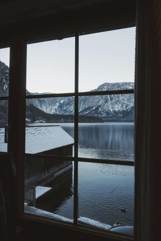 Ahmet Yüksek ✪ - Peaceful winter lake view framed by a window, capturing tranquility and reflection.