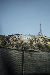 Alex Barnes - Vertical shot of the Hollywood Sign on a sunny day, with clear blue skies in Los Angeles, California.