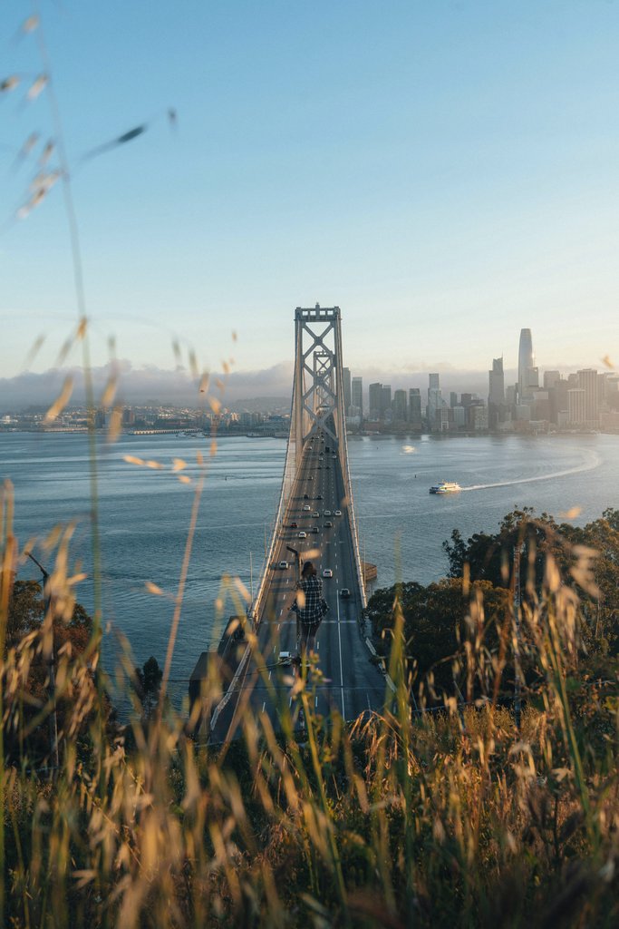 Lukas Rodriguez - Scenic view of Golden Gate Bridge leading to San Francisco cityscape at sunset.