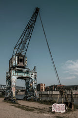 Wolfgang Weiser - Vibrant graffiti on an old crane in Hamburg's scenic harbour area.